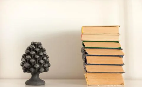 Stack of old book and vase, education concept background, many books piles wi Stock Photos