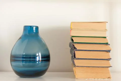 Stack of old book and vase, education concept background, many books piles wi Stock Photos