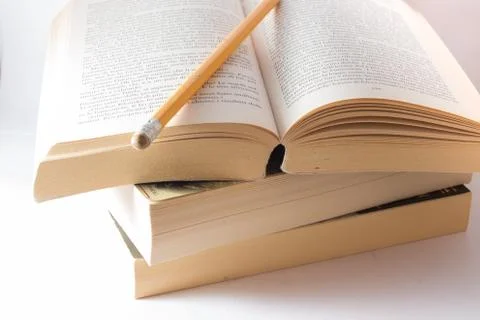 Stack of old books and pencil Stock Photos