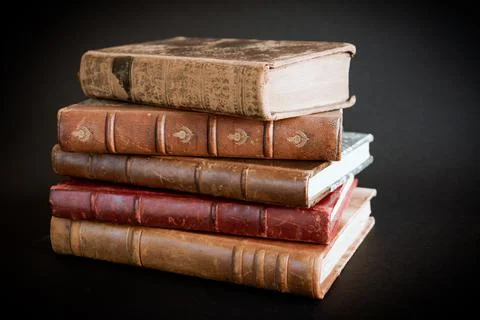 Stack of old books on black background Stock Photos