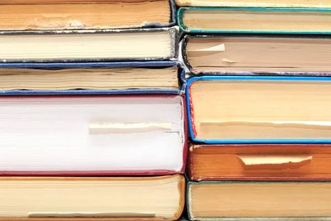 A stack of old books with bookmarks in different directions on different p... Stock Photos