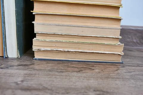 A stack of old books on the floor. Stock Photos