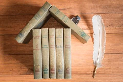 Stack of old books forming the figure of a house. Stock Photos