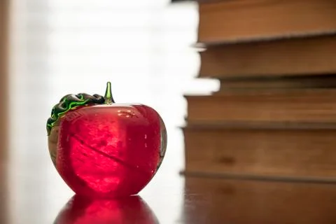 Stack of old books on kitchen table for study school apple Stock Photos