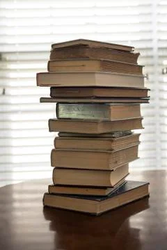 Stack of old books on kitchen table for study school Stock Photos