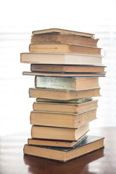 Stack of old books on kitchen table for study school Stock Photos