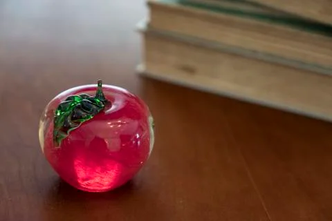 Stack of old books on kitchen table for study school apple Stock Photos