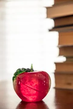Stack of old books on kitchen table for study school apple Stock Photos