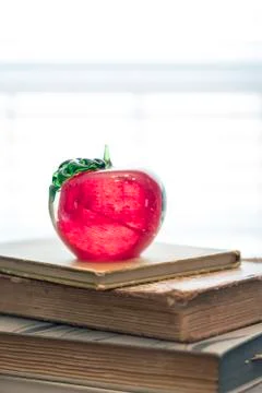 Stack of old books on kitchen table for study school apple Stock Photos