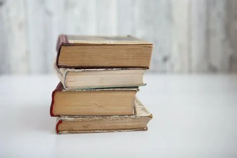 Stack of old books on light background Stock Photos