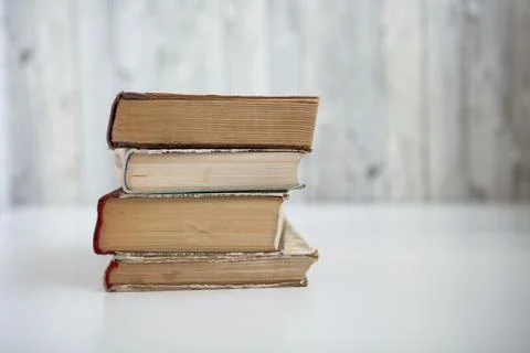 Stack of old books on light background Stock Photos