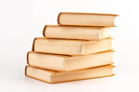 Stack of old books on light background. Book pile. Stock Photos
