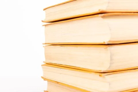 Stack of old books on light background. Book pile. Stock Photos