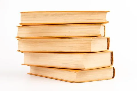 Stack of old books on light background. Book pile. Stock Photos