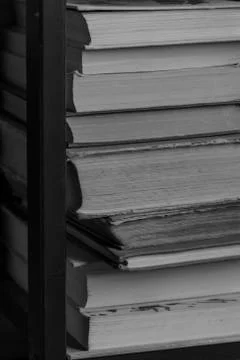 A stack of old books on the shelf. Texture pages of old books close up Stock Photos