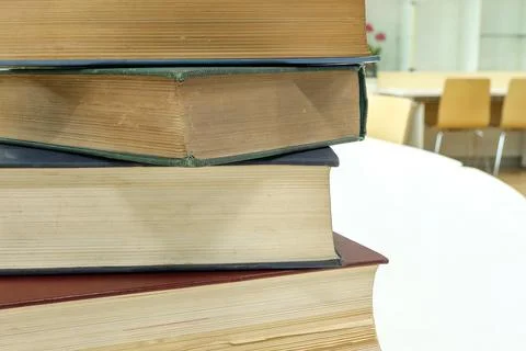 A stack of old books on table in library.Conceptual background on library,  Stock Photos