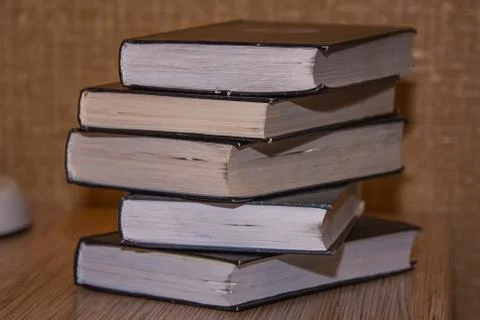 Stack of old books on the table side view Stock Photos