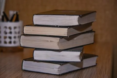 Stack of old books on the table side view Stock Photos