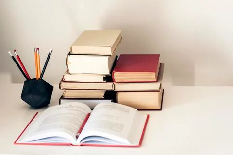 Stack of old books, textbook and pencils in office background for education c Stock Photos