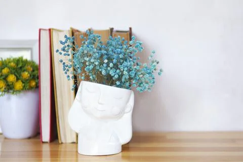 A stack of old books with vases of flowers. copy space. Stock Photos