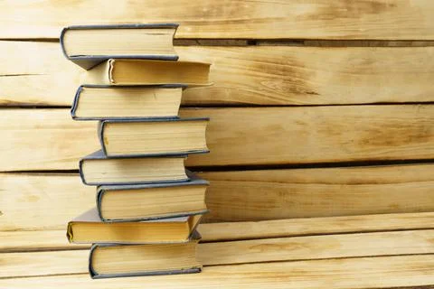 Stack of old books on wood background with copy space. Stock Photos