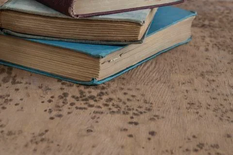 Stack of old books on a wooden table Stock Photos