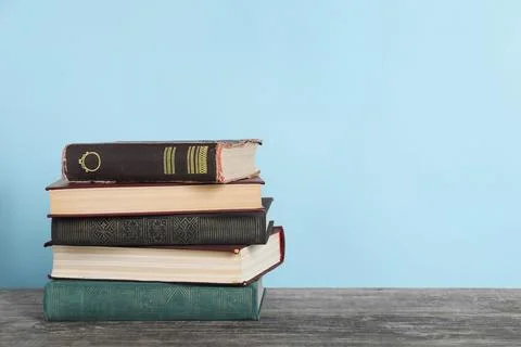 Stack of old books on wooden table, space for text 스톡 사진