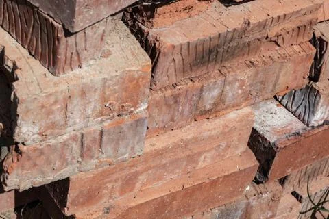 Stack of old bricks close up smoked weathered building background Stock Photos