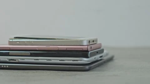 Stack of old broken smartphones and tablets placed on surface for recycling Stock Footage 340576149