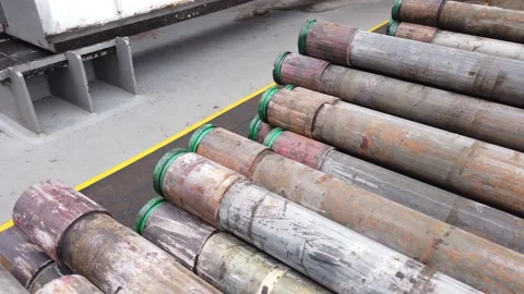 Stack of old casing conductor pulled out of hole Stock Footage 130478016