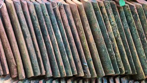 Stack of Old Clay Roof Tiles Covered with Moss Close Up Texture Stock Photos