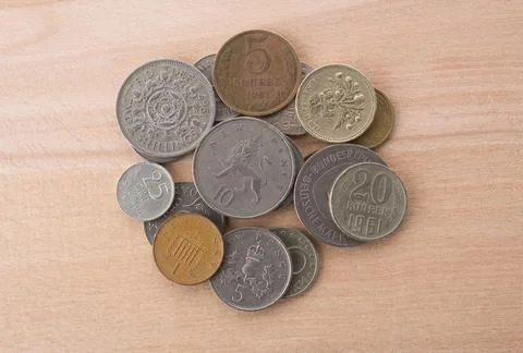 Stack of old coins on wooden background. Stock Photos