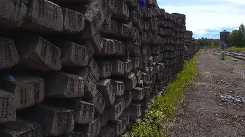 Stack of old concrete railroad sleepers near railway tracks Stock Footage 337409085