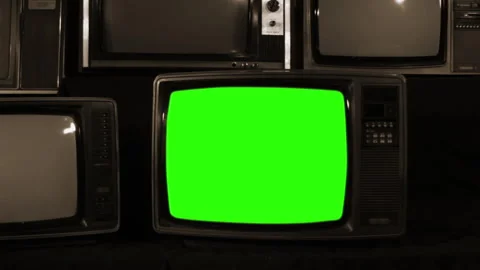 Stack of Old CRT Televisions With One Screen Turning Green - Sepia Tone Stock Footage 320167613