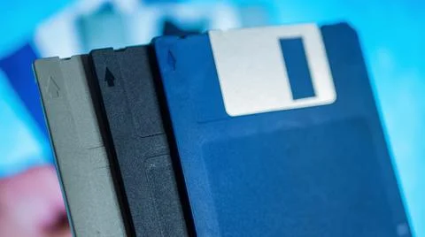 Stack of old diskettes in men hand Stock Photos
