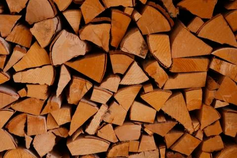 Stack of old firewood texture background.Fireplace wood, cordwood, splitwood. Stock Photos
