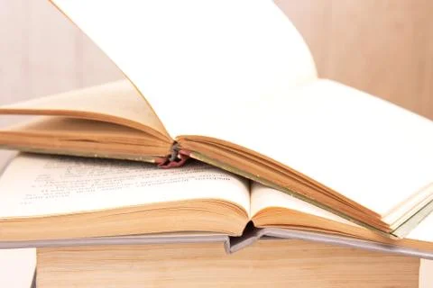 Stack of old hardback books and open book. Many Books Piles. Hardback books o Stock Photos