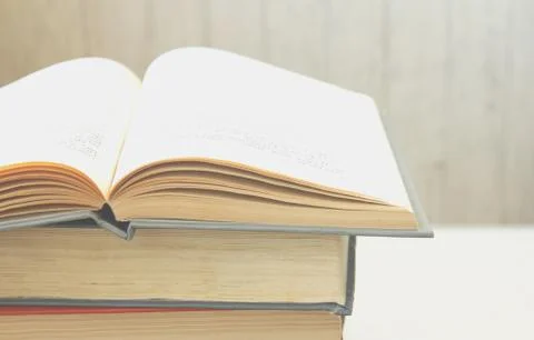Stack of old hardback books and open book. Many Books Piles. Hardback books o Stock Photos