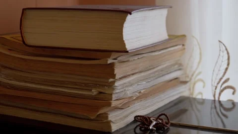 Stack of old knowledge books with a christian cross 스톡 동영상 343994742