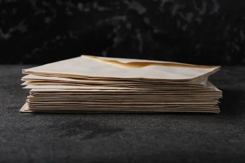 Stack of old letter envelopes on grey table, closeup Foto stock
