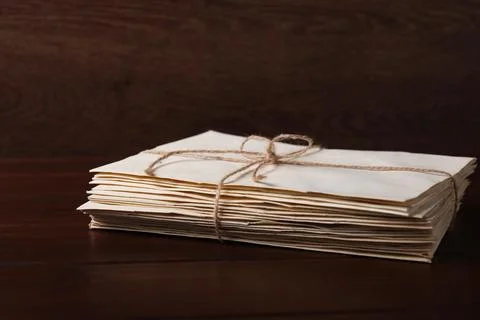 Stack of old letters tied with twine on wooden table, closeup 스톡 사진