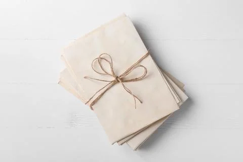 Stack of old letters tied with twine on white wooden table, top view Stock Photos
