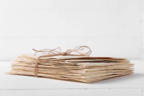 Stack of old letters tied with twine on white wooden table, closeup Stock Photos