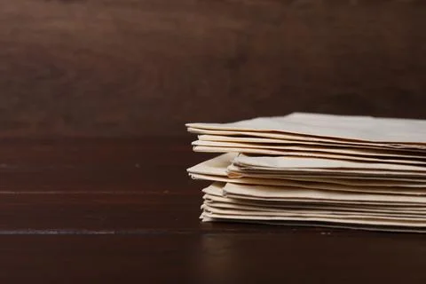 Stack of old letters on wooden table, closeup. Space for text Stock Photos