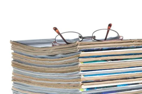 Stack of old magazines &amp; reading glasses Stock Photos