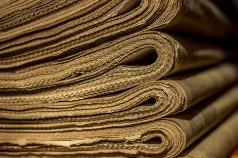 Stack of old newspapers on the shelf. closeup Stock Photos