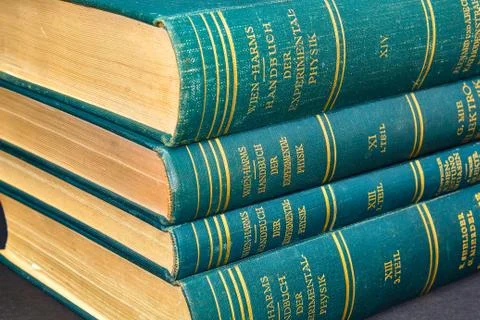 A stack of old often used physics books 写真素材