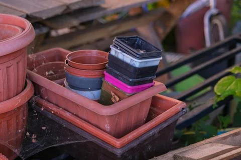 Stack of old pot and plastic seed trays in various sizes and colors, ready for Stock Photos
