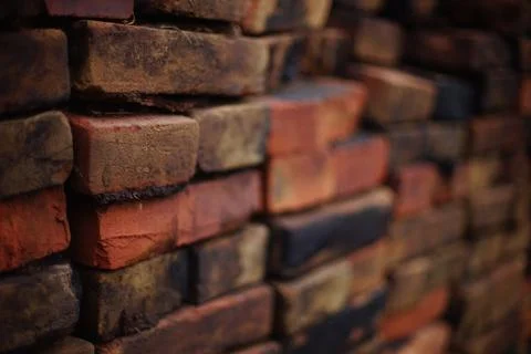 Stack of old red and black bricks 스톡 사진