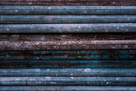 Stack of old rusty aged metal iron plumbing pipes. Background. Texture Stock Photos